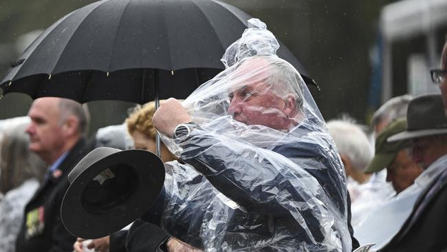 The Nationals MP was seen tussling with a disposable rain cover. Picture: NCA NewsWire Martin Ollman