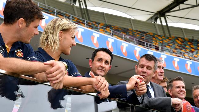 Queensland Premier David Crisafulli and Cricket Australia chairman (and former NSW Liberal premier) Mike Baird chat with Brisbane Lions’ players at the Gabba. Picture: NewsWire / John Gass