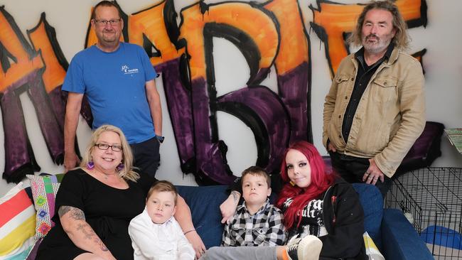 Local mum Bec Provis has autism and adhd, and she has five kids that all have special needs/mental health issues. She has founded a service for people with disability called AmAble in Belmont. Pictured is Bec with some of her kids Jack 8 William 10, Danni in the background is husband Hew Provis (left) and their artist employee Pat Brady (right) Picture: Mark Wilson