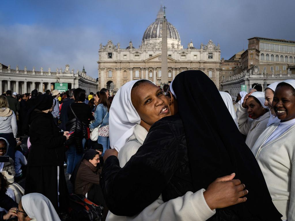 Nuns hug in front of St Peter's Basilica. Picture: AFP