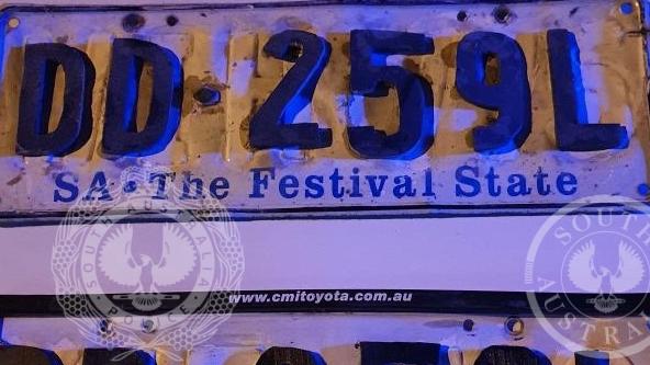 Man alters plates in Salisbury Heights. Picture: SA Police