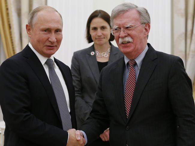 Russian President Vladimir Putin, left, and U.S. National security adviser John Bolton shakes hands during their meeting in the Kremlin in Moscow, Russia, Tuesday, Oct. 23, 2018. Putin poked fun at the official seal of the United States while hosting U.S. President Donald Trump's national security adviser Tuesday, saying he wondered if the American eagle had plucked all the olives from the branch in its talon. (AP Photo/Alexander Zemlianichenko)