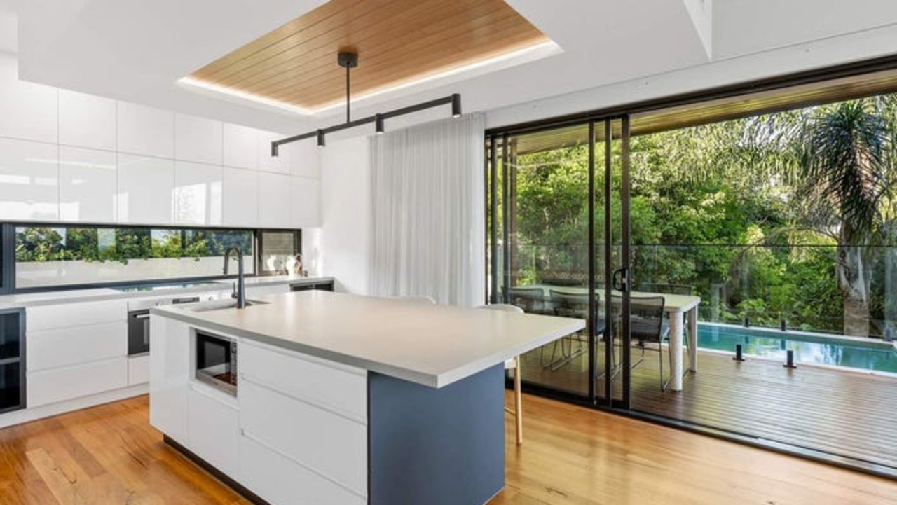 A contemporary kitchen anchors open-plan living spaces