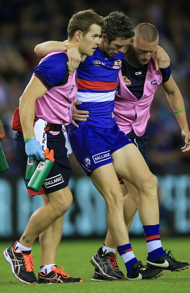 Bob Murphy is helped off the ground after his season-ending knee injury. Picture: Wayne Ludbey