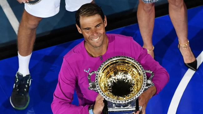 A beaming Nadal holds the Australian Open trophy after his five-set win.