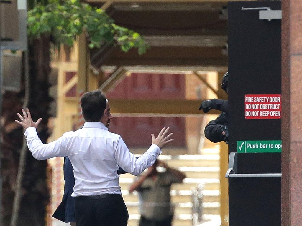 Hostages John O’Brien and Stefan Balafoutis (white shirt) were the first to make their escape and run to safety. Picture: Getty Images