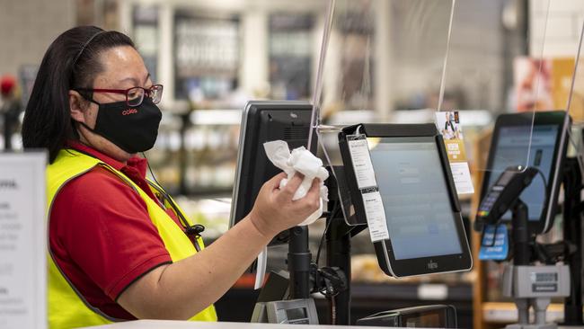 Coles staff photographed sanitising at Eastgate Bondi Junction on Tuesday. Picture: Monique Harmer