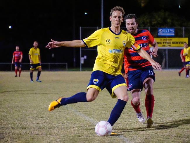 Gold Coast United defender and captain Micahel Thwaite shields the ball in their pre-season match with Gold Coast Premier League club Nerang Eagles. Photo: Luke Sorensen