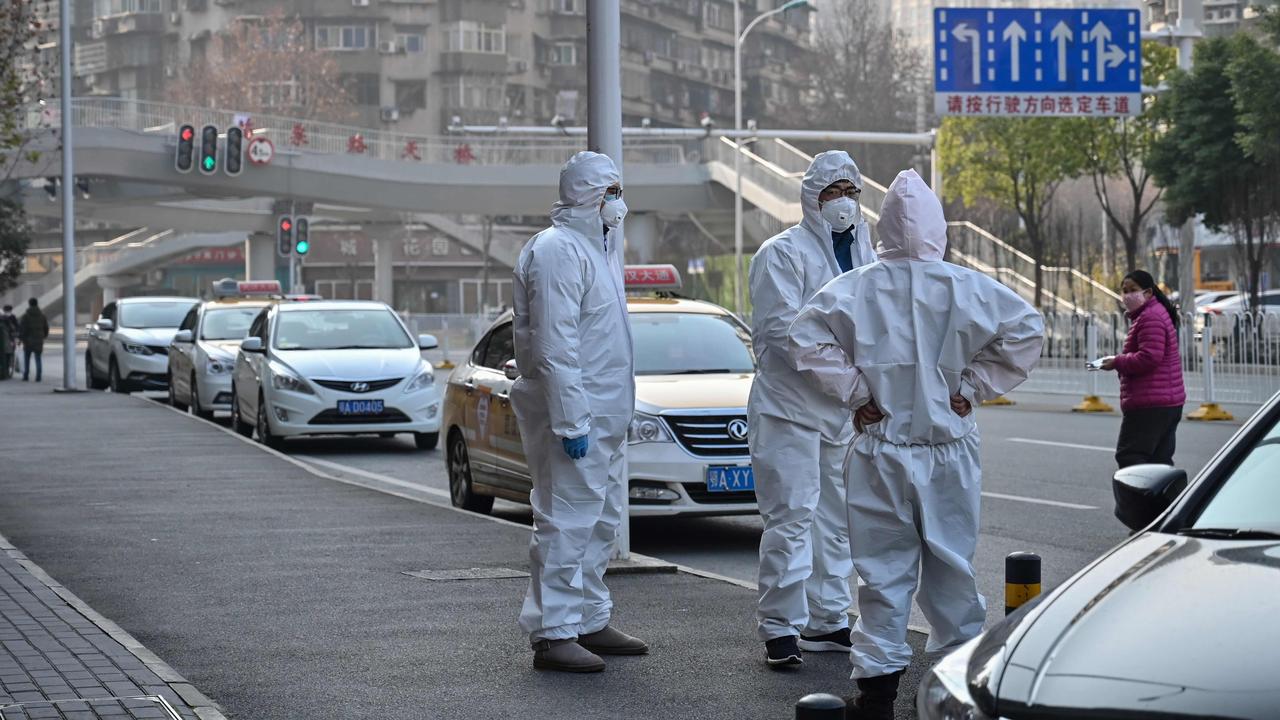 Officials in protective suits in Wuhan. Picture: Hector Retamal/AFP