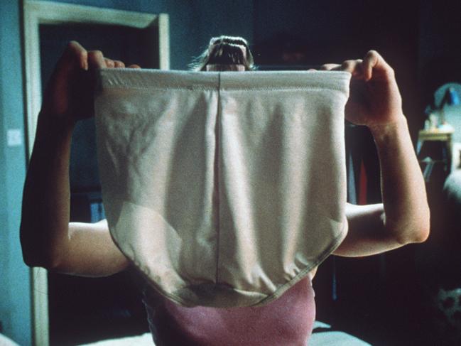 Actress Renee Zellweger holds up a giant pair of tummy-firming control pants in the 2001 film Bridget Jones's Diary.movies scene large plus size underpants underwear Picture: Supplied