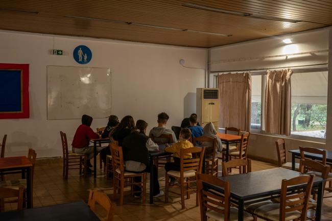 Teenagers from Santorini in a summer camp near Athens housing families from the quake-hit island