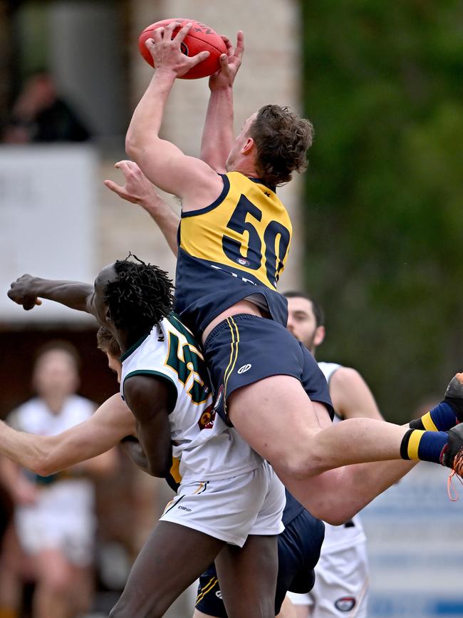 Hurstbridge’s Joel Naylor marks over Northcote Park’s Ayui Makiemg. Picture: Andy Brownbill