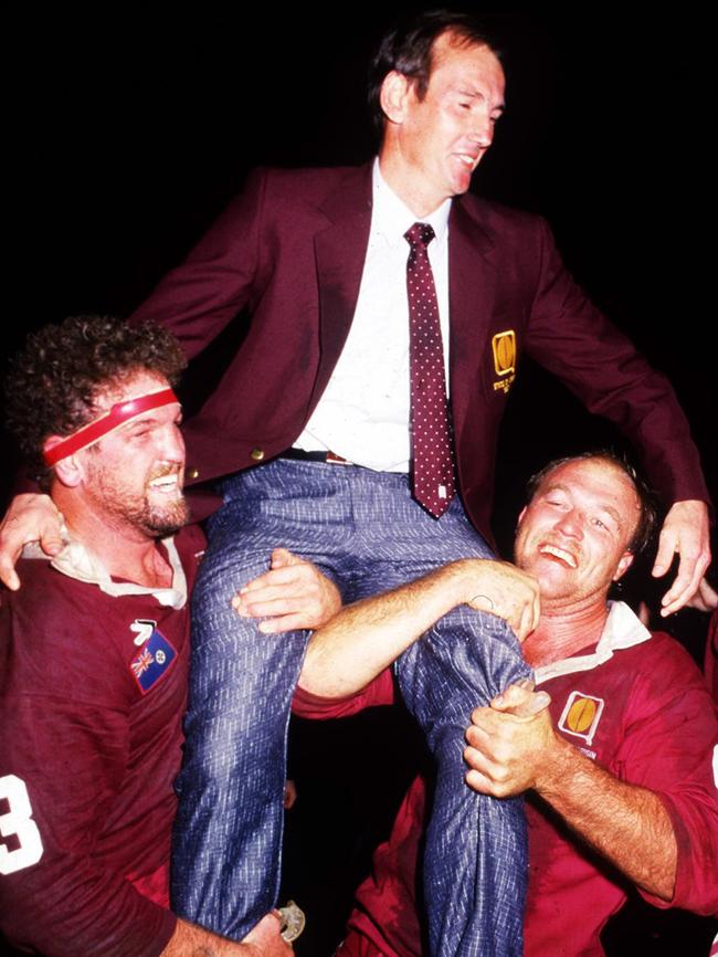 Greg Dowling and Wally Lewis lift Wayne Bennett onto their shoulders after winning Game One in 1987.