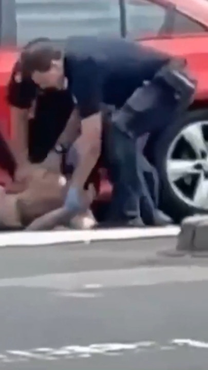 Police caught on video punching and kneeling on a man