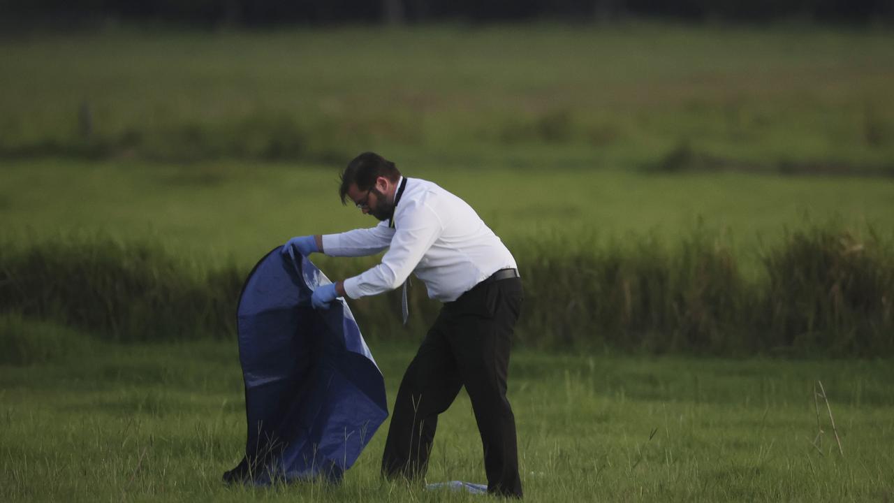 Investigators at the scene of plane wreckage at Kybong where two aeroplanes collided leaving two people dead. Picture Lachie Millard