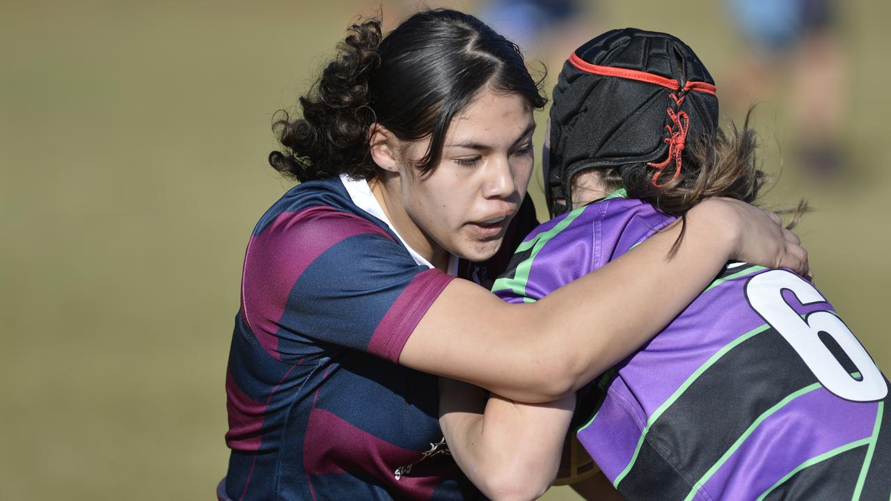 Tiresa Elika (left) of Ipswich State High School tackles Lucy Davis of Wilsonton State High School in junior girls rugby league at WSHS, Tuesday, August 18, 2020. Picture: Kevin Farmer