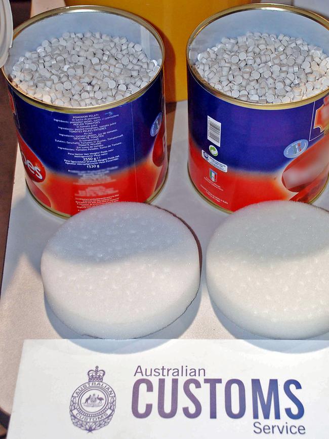 Australian Customs display some of the seized 4.4 tonnes of ecstasy tablets in tomato tins.