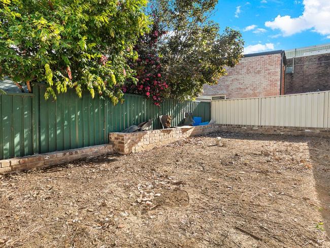 The backyard once had an overgrown garden and lawn.