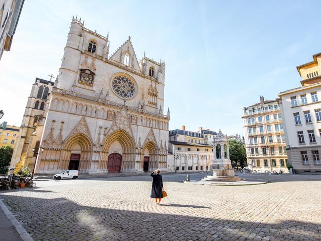 ESCAPE: France History, Eliza Compton -  Morning view on the saint John cathedral with woman walking on the square in the old town of Lyon city  Picture: Istock