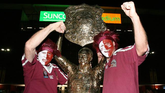 Queensland fans Darren and Carl Robinson pose with the Wally Lewis statue outside Suncorp Stadium.