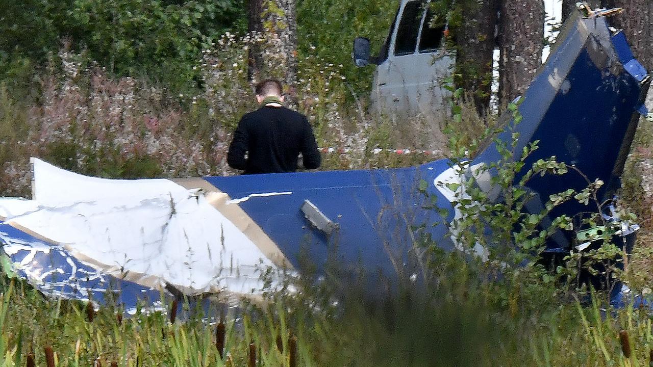 A law enforcement officer works at the site of a plane crash. Picture: AFP