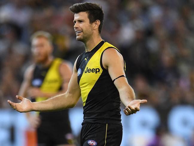 Trent Cotchin of the Tigers reacts after a 50m penalty was awarded against him during the Round 1 AFL match between the Richmond Tigers and the Carlton Blues at the MCG in Melbourne, Thursday, March 22, 2018. (AAP Image/Julian Smith) NO ARCHIVING, EDITORIAL USE ONLY