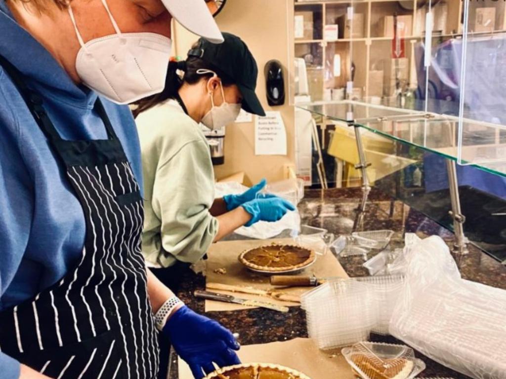 Meghan Markle can be seen helping to prepare a Thanksgiving meal for homeless women in the photo uploaded to the Archewell website. Picture: Archewell