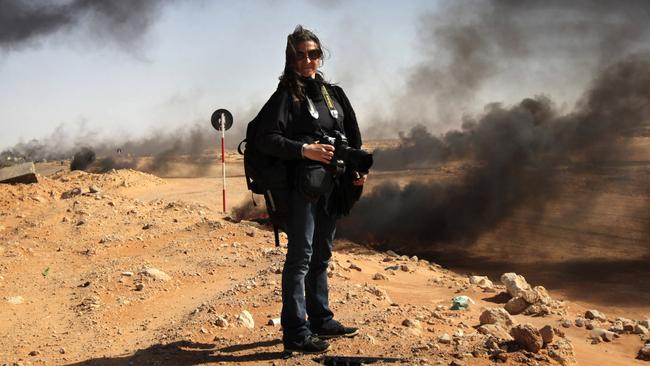 RAS LANUF, LYBIA - MARCH 18: New York Times photographer Lynsey Addario stands near the frontline during a pause in the fighting March 11, 2011 in Ras Lanuf, Libya. Four New York Times journalists, the Beirut bureau chief Anthony Shadid, photographers Tyler Hicks and Lynsey Addario and a reporter and videographer, Stephen Farrell have been missing since March 15, 2011, were reportedly taken by loyalist Libyan forces, and will be released today, March 18. (Photo by John Moore/Getty Images)