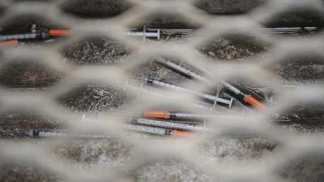 Syringes under a walkway grill in Richmond.