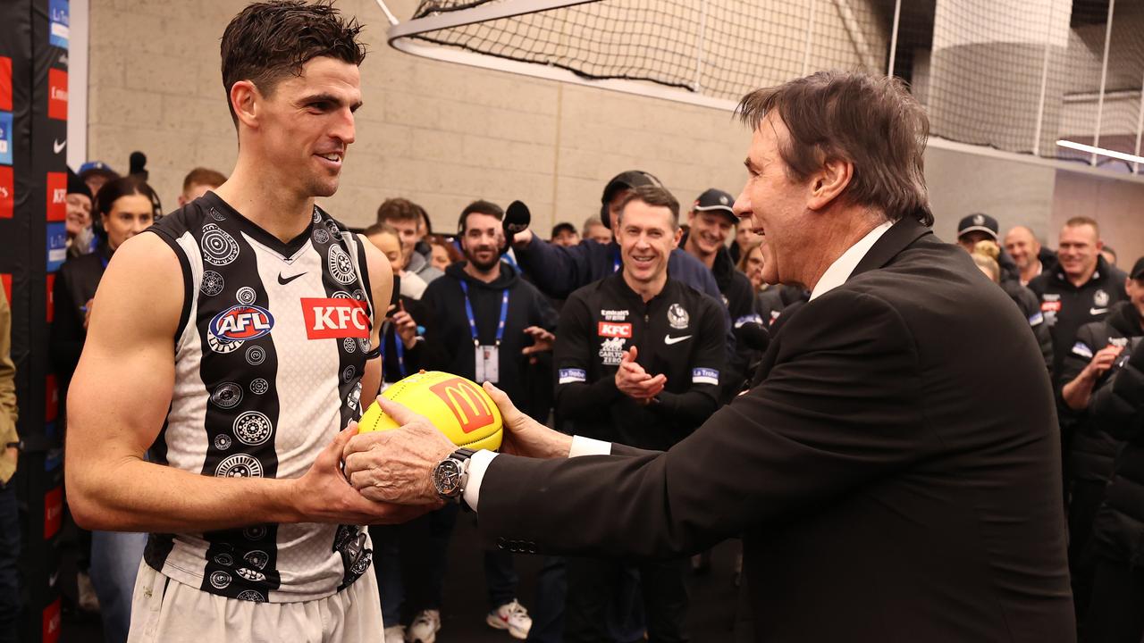 Jeff Browne presenting Scott Pendlebury with the game ball after he broke the AFL disposal record. Picture: Michael Klein