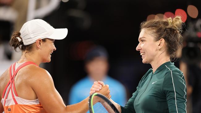 Ashleigh Barty (L) embraces Simona Halep after an exhibition game in 2021. Picture: Getty