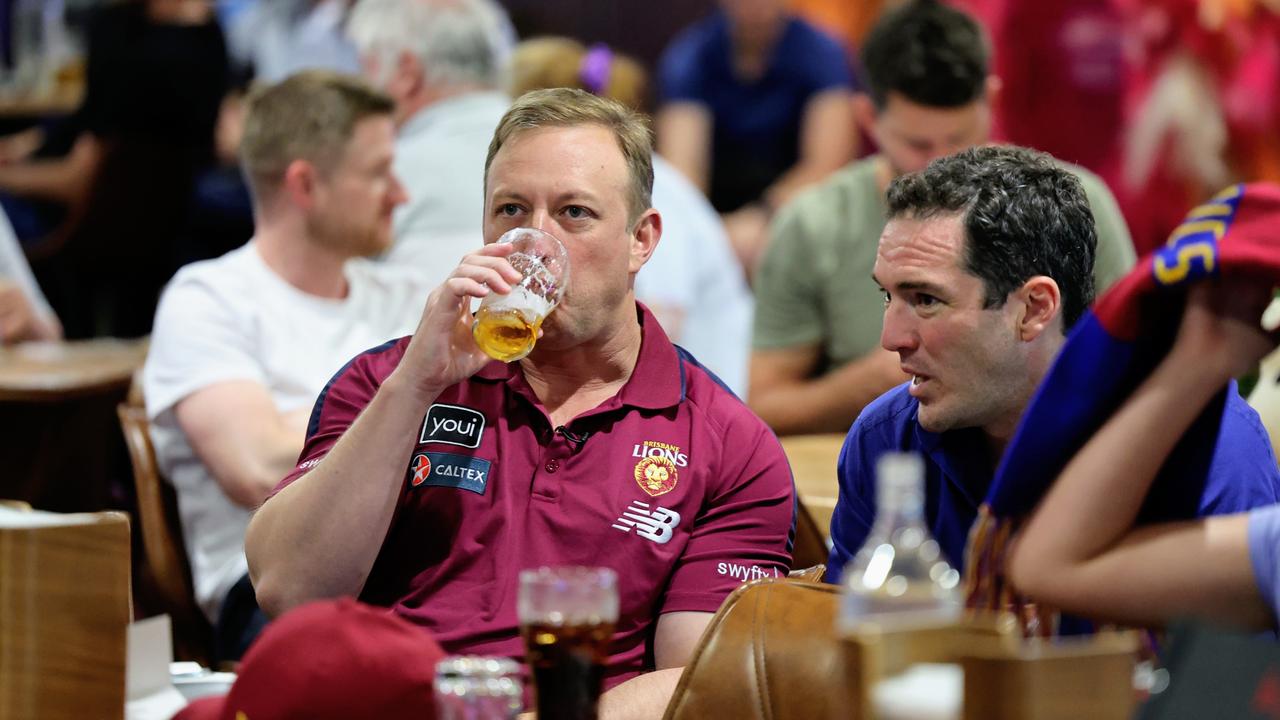 Queensland Premier Steven Miles has a beer while watching the 2024 AFL grand final match between the Brisbane Lions and the Sydney Swans at Cazalys Sports Club, Cairns. Picture: Brendan Radke