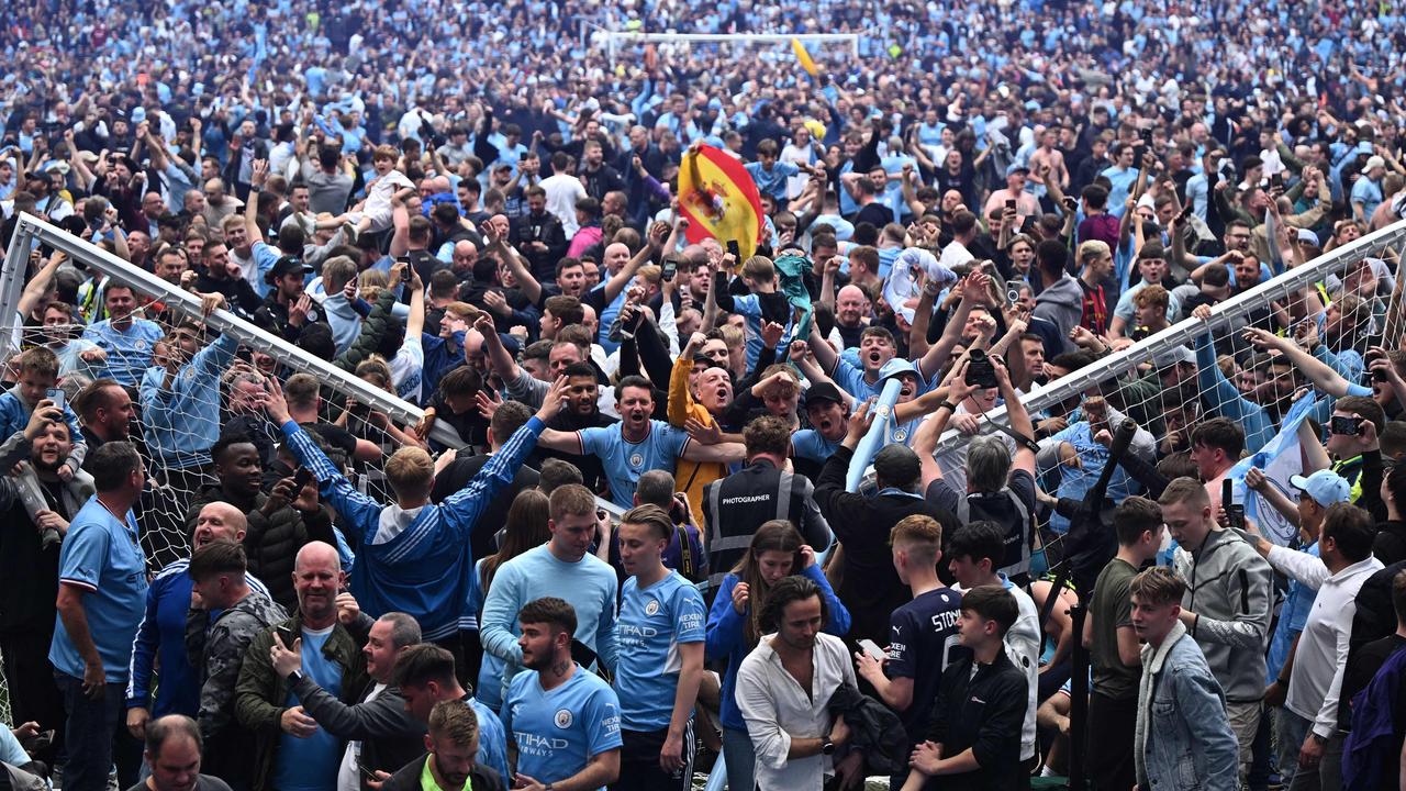 A pitch invasion from Manchester City’s fans capped off a chaotic final 15 minutes against Aston Villa. (Photo by Oli SCARFF / AFP)