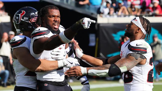 Azeez Al-Shaair #0 of the Houston Texans points to the Jacksonville Jaguars bench after a fight and being ejected. Mike Carlson/Getty Images/AFP