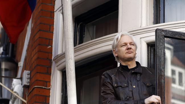 WikiLeaks founder Julian Assange looks out from the balcony while claiming political asylum at the Ecuadorean embassy in London in 2017. Picture: AFP