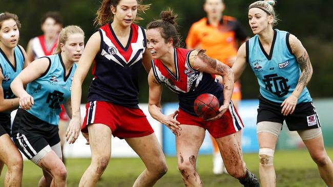 Darebin Falcons captain Daisy Pearce tries to break clear of a pack against Eastern Devils on Sunday. Photo: Paul Loughnan