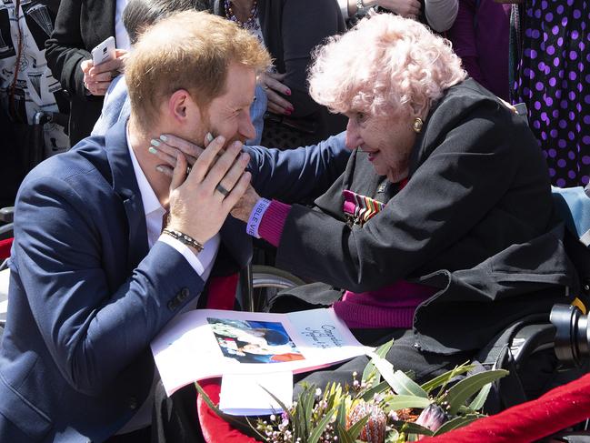 Prince Harry is embraced by 98-year-old Daphne Dunne during a walk in front of the Opera House. Picture: Paul Edwards/AP