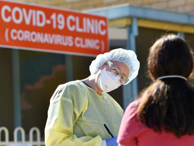 Hospital staff test people outside the Tanunda War Memorial Hospital, a dedicated COVID-19 testing clinic to deal with the expected uptick in cases in the Barossa Valley, northeast of Adelaide, Tuesday, March 31, 2020. The Barossa Valley has had a cluster of 34 cases of coronavirus. (AAP Image/David Mariuz) NO ARCHIVING