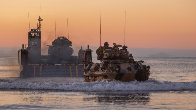 An Australian light armoured vehicle rolls off HMS Canberra’s landing craft on to Forrest Beach, near Ingham in north Queensland.