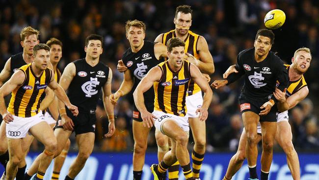 Sam Petrevski-Seton of the Blues is tackled by Tom Mitchell of the Hawks during the round 18 AFL match between the Carlton Blues and the Hawthorn Hawks. Picture: Michael Dodge/Getty Images