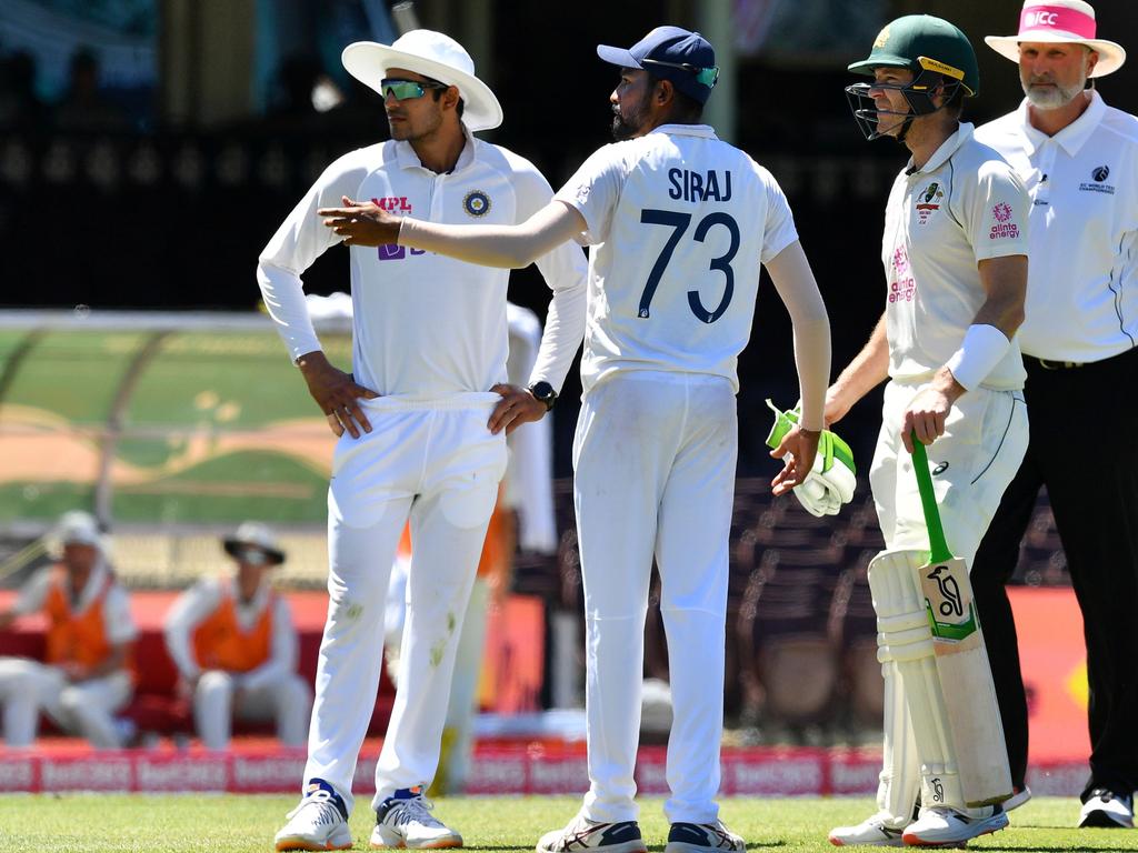 India's Mohammed Siraj gestures as Australia's captain Tim Paine looks on.