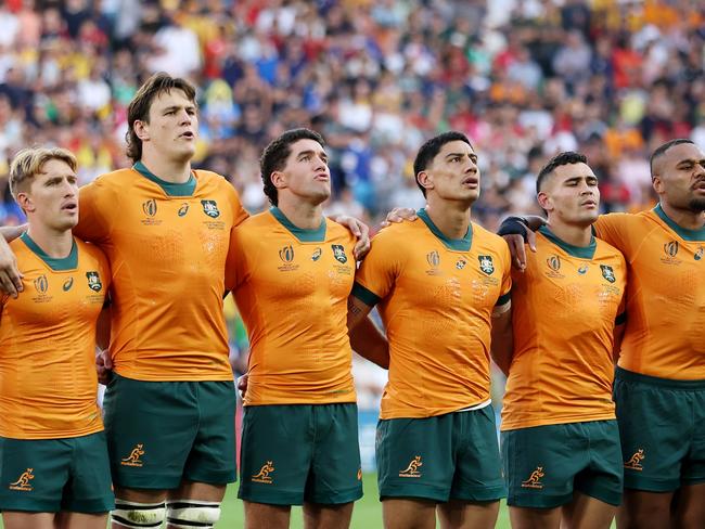 SAINT-ETIENNE, FRANCE - OCTOBER 01: The players of Australia line up during the National Anthems prior to the Rugby World Cup France 2023 match between Australia and Portugal at Stade Geoffroy-Guichard on October 01, 2023 in Saint-Etienne, France. (Photo by Chris Hyde/Getty Images)