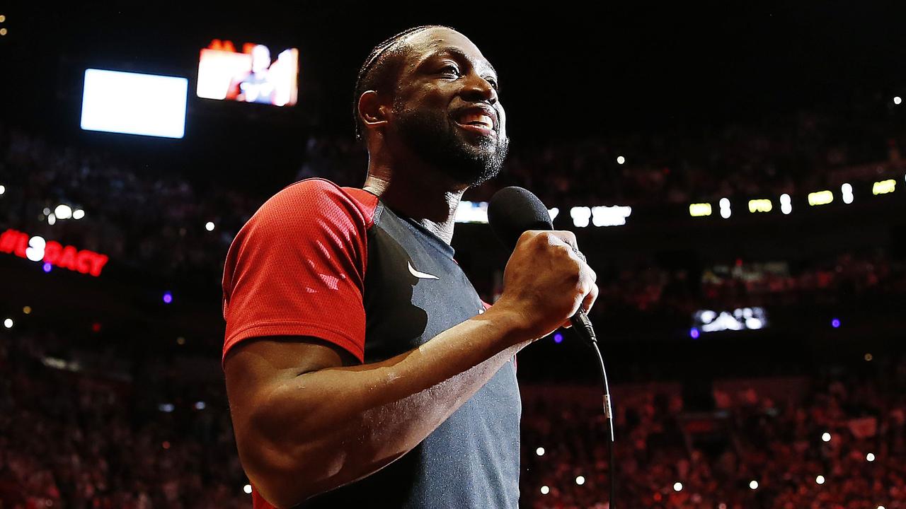 Dwyane Wade addresses the crowd during a ceremony commemorating the final regular season home game of his career.
