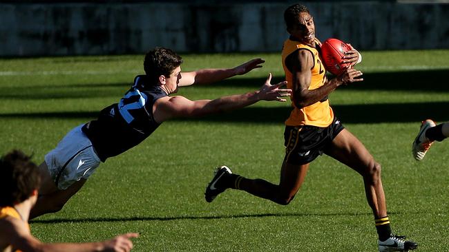 Vic Metro v Western Australia at Simonds Stadium, WA's Jarrod Garlett gets past an outstretched Metro's Angus Brayshaw.June 27th 2014. Picture : Colleen Petch