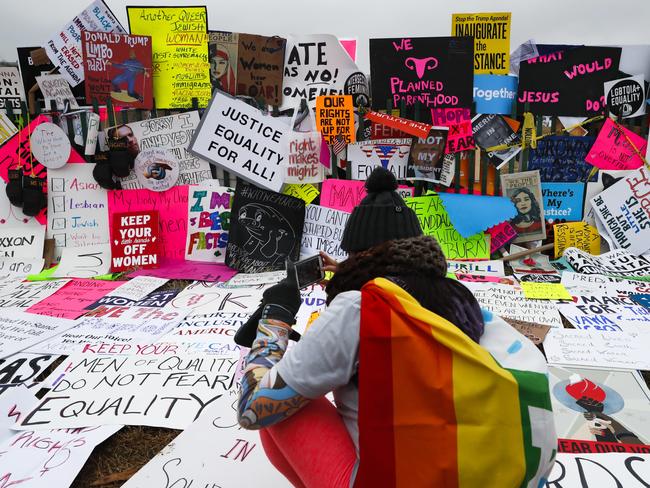 Protesters build a wall of signs outside the White House for the Women's March on Washington. Picture: AP Photo/John Minchillo