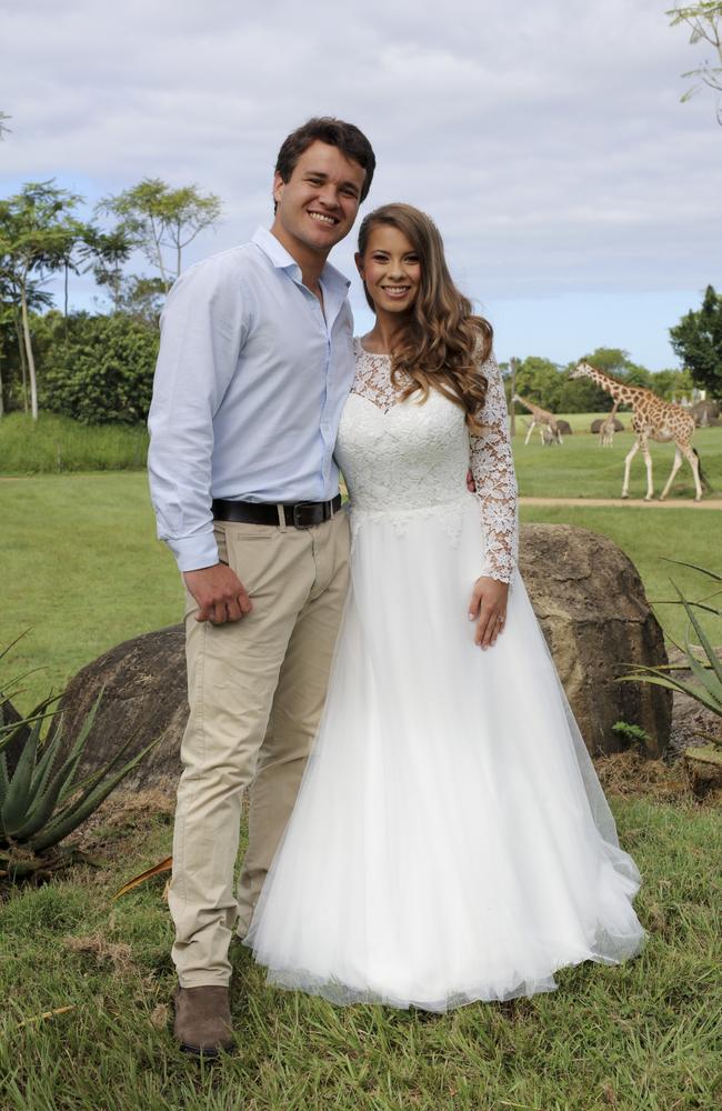 Chandler Powell and Bindi Irwin on their wedding day with giraffe in the background Picture: Kate Berry