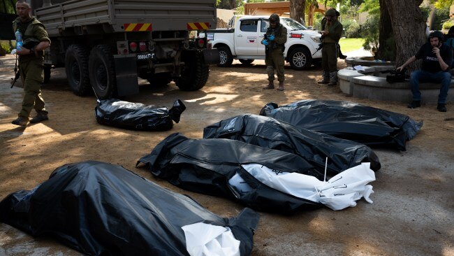 Four bodies of Israeli civilians killed days earlier in an attack by Hamas militants wait to be collected on October 10, 2023 in Kfar Aza, israel. Picture: Getty Images.