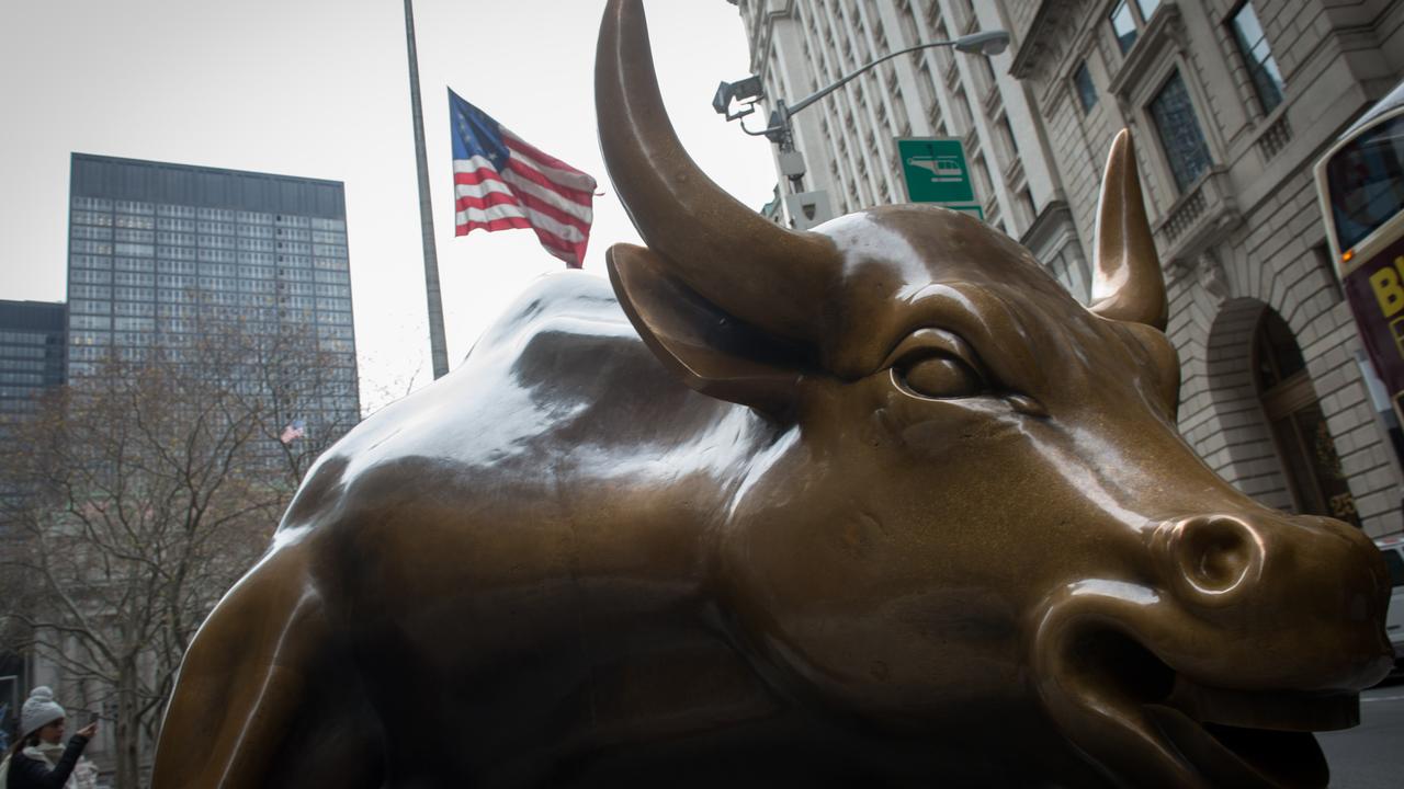 (FILES) This file photo taken on December 8, 2016 shows the Wall Street Bull sculpture is seen in the Financial District in New York.  Wall Street opened on the upside, with the Dow pushing further higher after having finished Monday at a fourth-straight record high, and nearing breaking through 22,000 points for the first time ever. "US stocks are nicely higher in early action, with the global markets reacting positively to the continued mostly upbeat earnings season and favourable manufacturing data out of Europe and Asia," said analysts at Charles Schwab brokerage.  / AFP PHOTO / Bryan R. Smith