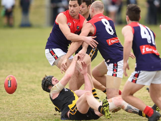 Seaford’s Kyle Matthews is swamped by Mt Eliza opponents. Picture: Chris Eastman