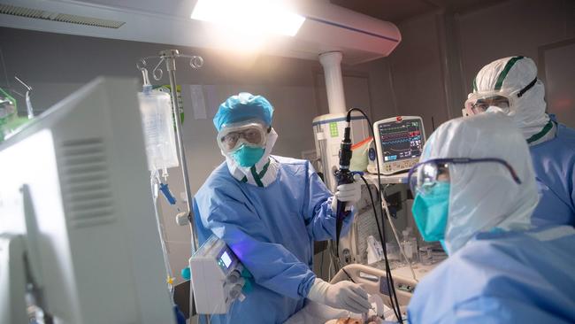 Medical staff treat a COVID-19 patient at a hospital in Wuhan, China. Picture: AFP